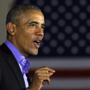 Obama slams 'politics of division' on return to campaign trail